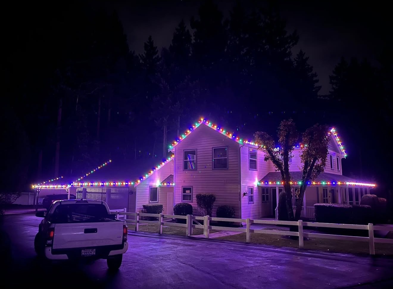 Home with classic multicolor C9 Christmas lights on the roofline