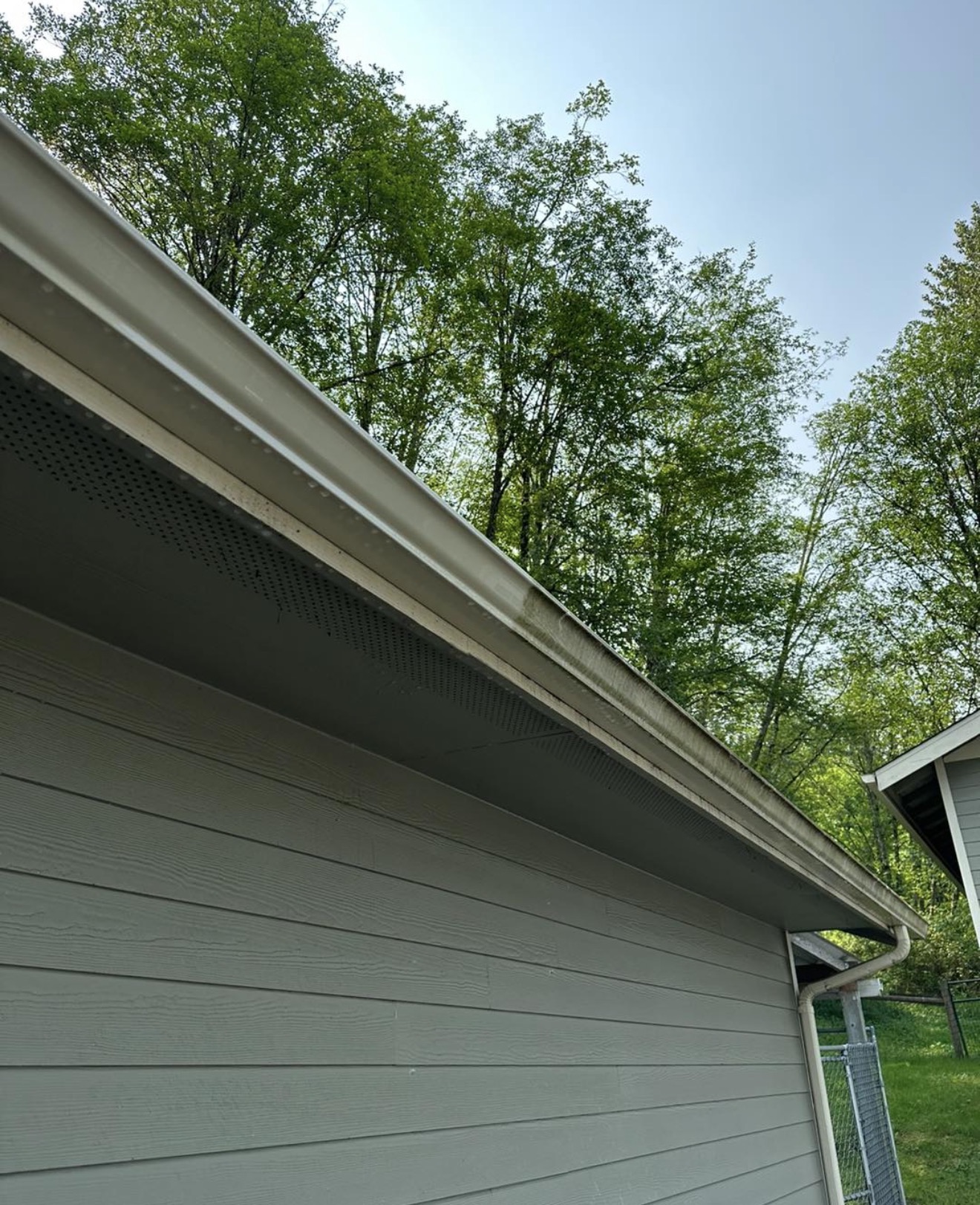 Gutter exterior showing oxidation and tiger stripes before brightening