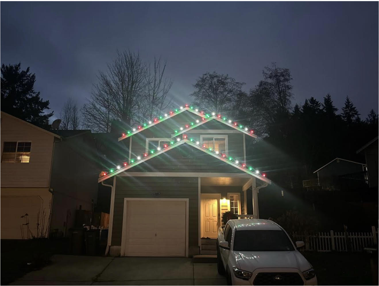 Kitsap County home with red, white and green C9 Christmas lights along the roofline